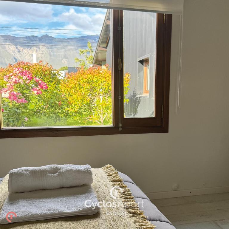 a bedroom with a window with a view of the grand canyon at CyclosApart in Esquel