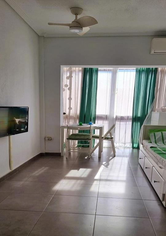 A television and/or entertainment centre at Cosy studio apartment in Torrevieja