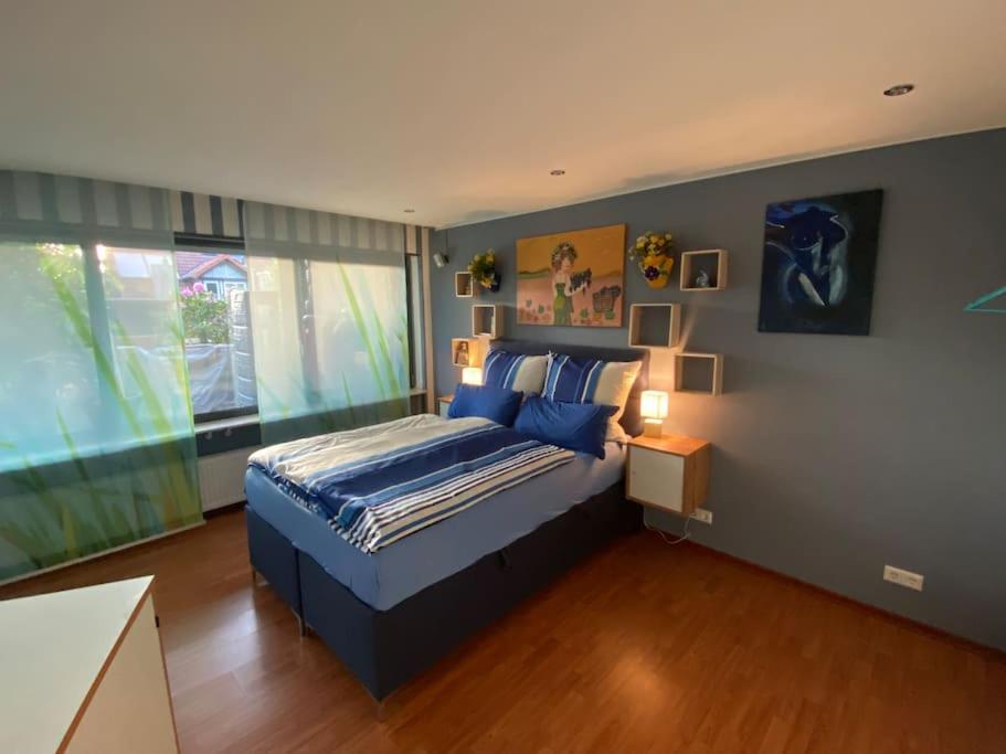 a bedroom with a bed and a large window at Ilonas Home in Baden-Baden