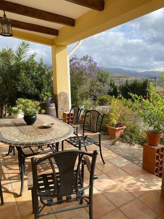 a table and chairs on a patio with a view at Cortijo Estrella in Serón