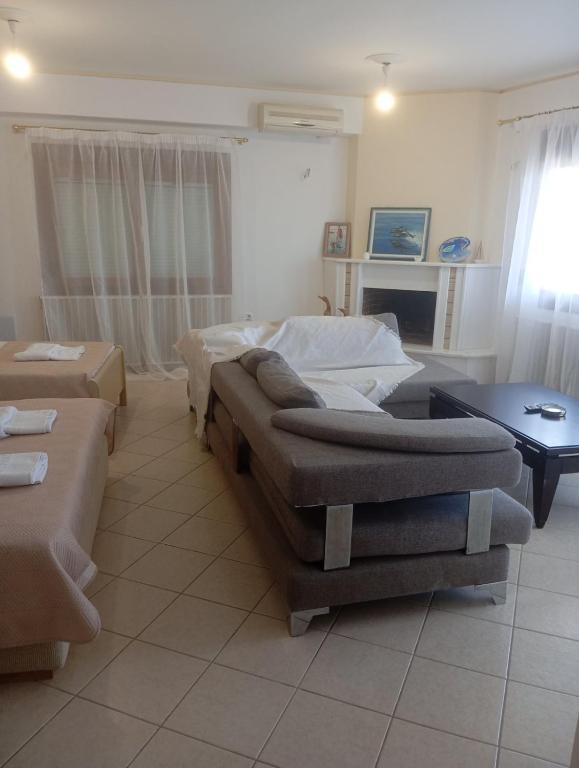 a living room with two couches and a couch at Sweet Home in Platamonas