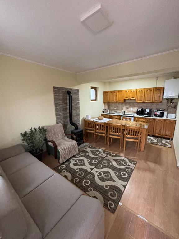 a kitchen and living room with a couch and a table at Casa Iuliana in Sovata