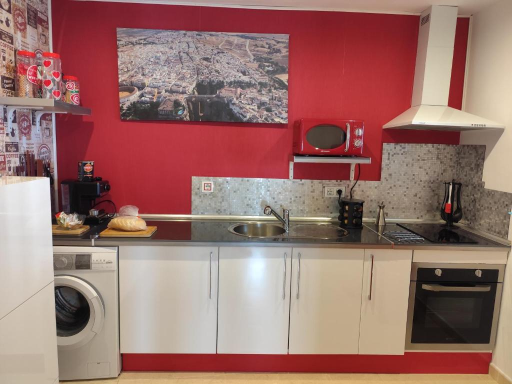 A kitchen or kitchenette at ÁTICO RILQUE, Apartamentos Independientes con Jacuzzi Privado y Terraza en Ronda