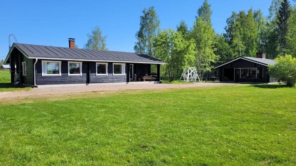 a house with a large yard in front of it at Rytkynranta Village 