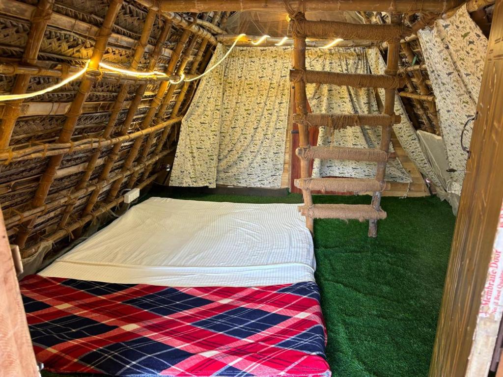 a chair sitting in the inside of a tent at Bamboo hutz in Jāmb