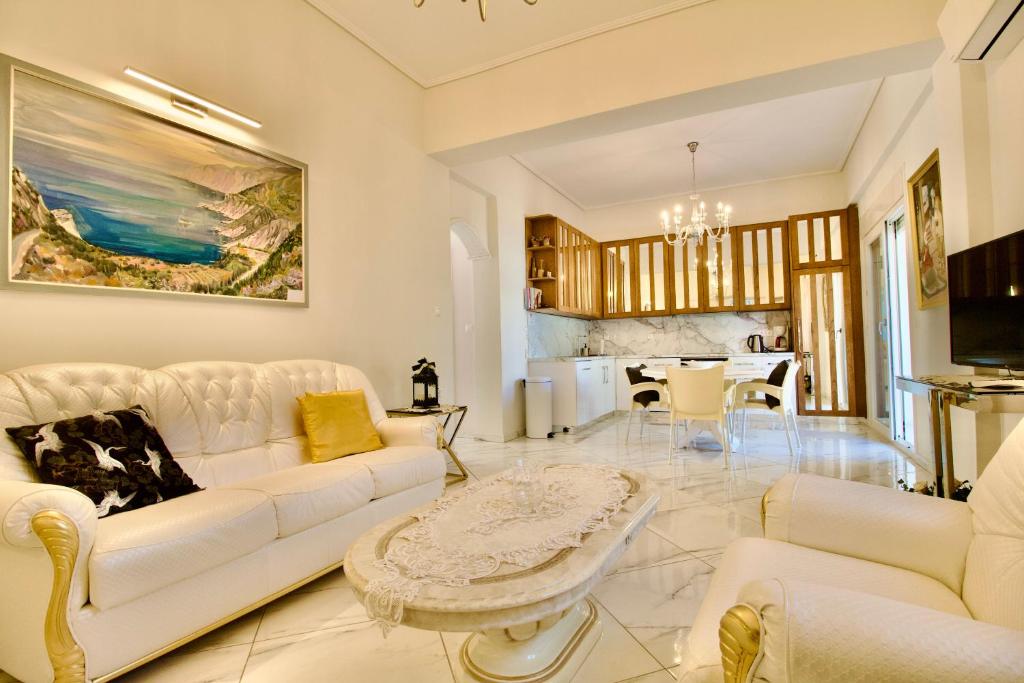 a living room with a white couch and a table at Central Luxurious Retreat in Argostoli