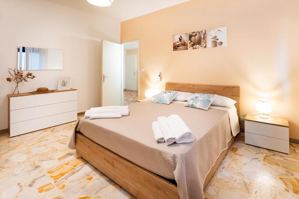 a bedroom with a large bed with towels on it at Casa Donna Celestina in Letojanni