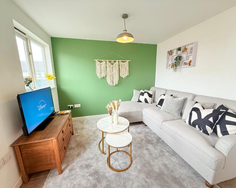 a living room with a couch and a tv at Penthouse with City Views in Bristol