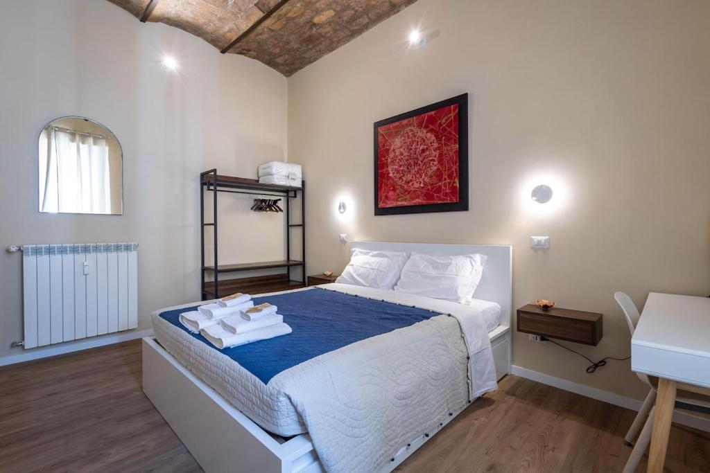 a bedroom with a bed with towels on it at The Heartbeat of Bohemian Rome in Rome
