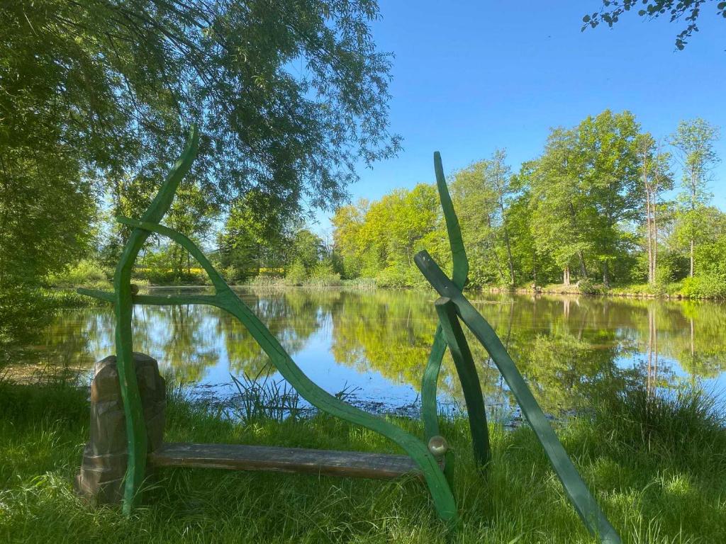 a metal sculpture in front of a lake at Ganzes Tiny House "Thüringer Ruhe" mit großem Garten nahe Rennsteig in Laucha