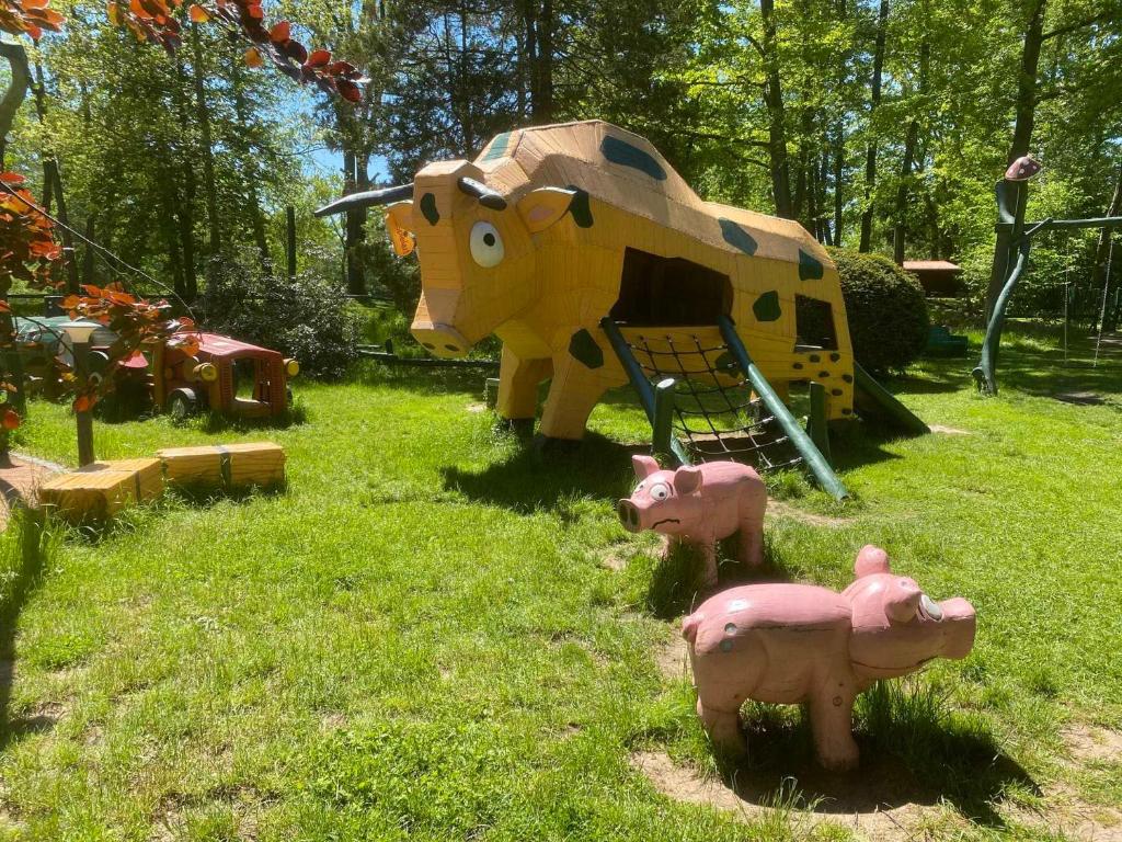 a playground with fake animals in the grass at Ganzes Tiny House "Thüringer Ruhe" mit großem Garten nahe Rennsteig in Laucha