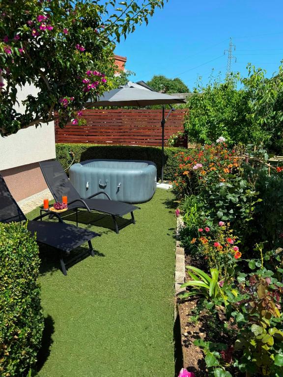 a garden with a bathtub in the middle of a yard at Jacuzzi House Kaštela - Parking - Playground in Kaštela