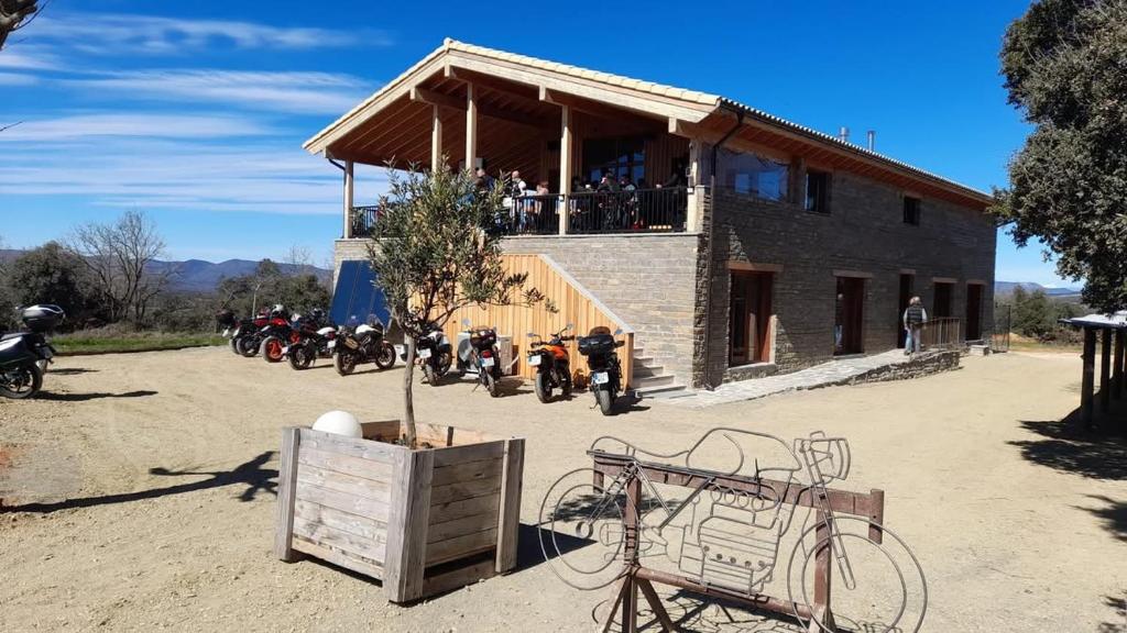 a group of motorcycles parked in front of a building at Moto Albergue Farango FOR MOTORBIKERS ONLY - SOLO PARA MOTEROS in Benabarre