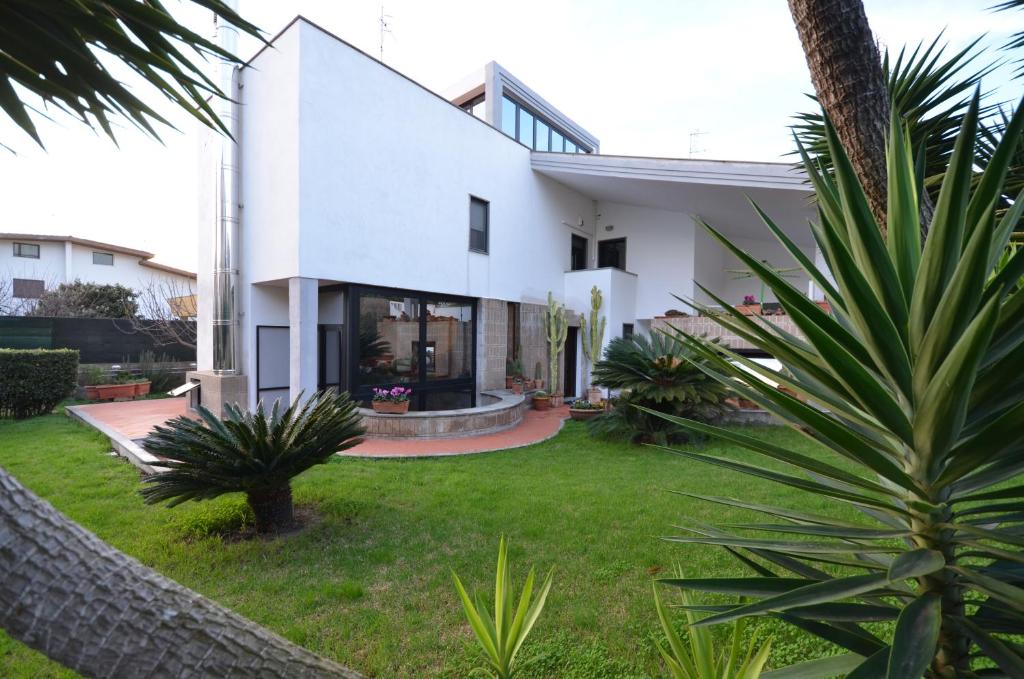 a white house with a yard at Acquamarina in Civitavecchia