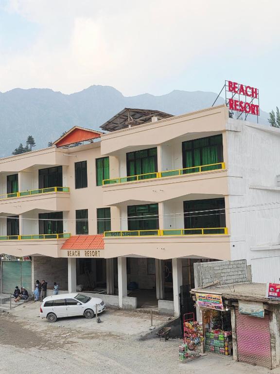 a building with a car parked in front of it at Beach Resort in Kalām