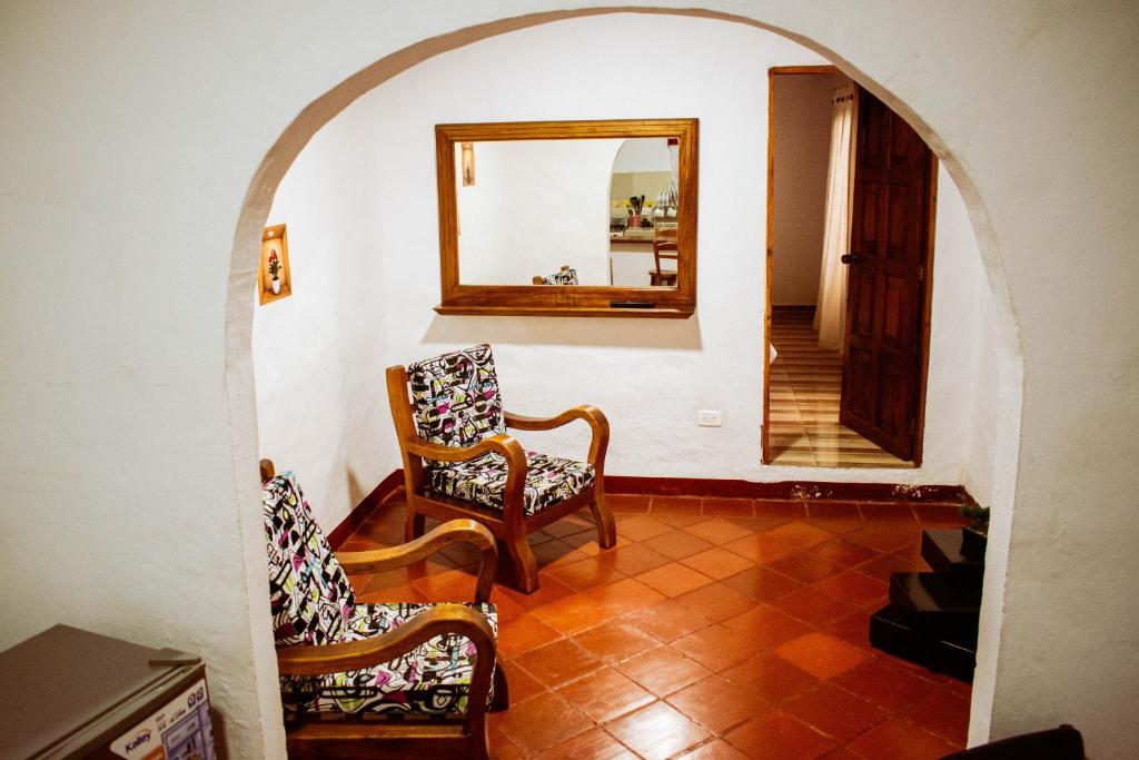 a room with a chair and a mirror and a stairway at Apartahotel Casa de Angel in Villa de Leyva