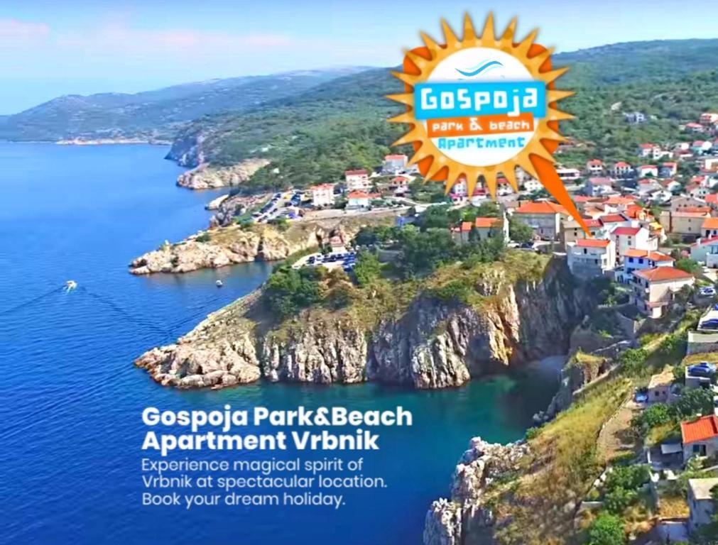 a view of a small town on a cliff next to the ocean at Gospoja Park & Beach Apartment Vrbnik in Vrbnik