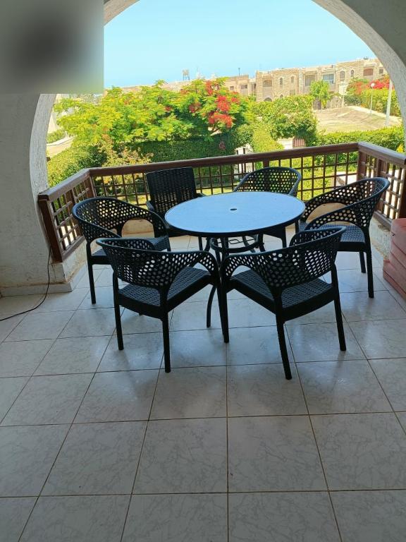 a patio with a table and chairs on a balcony at شاليه مارينا 6 in El Alamein