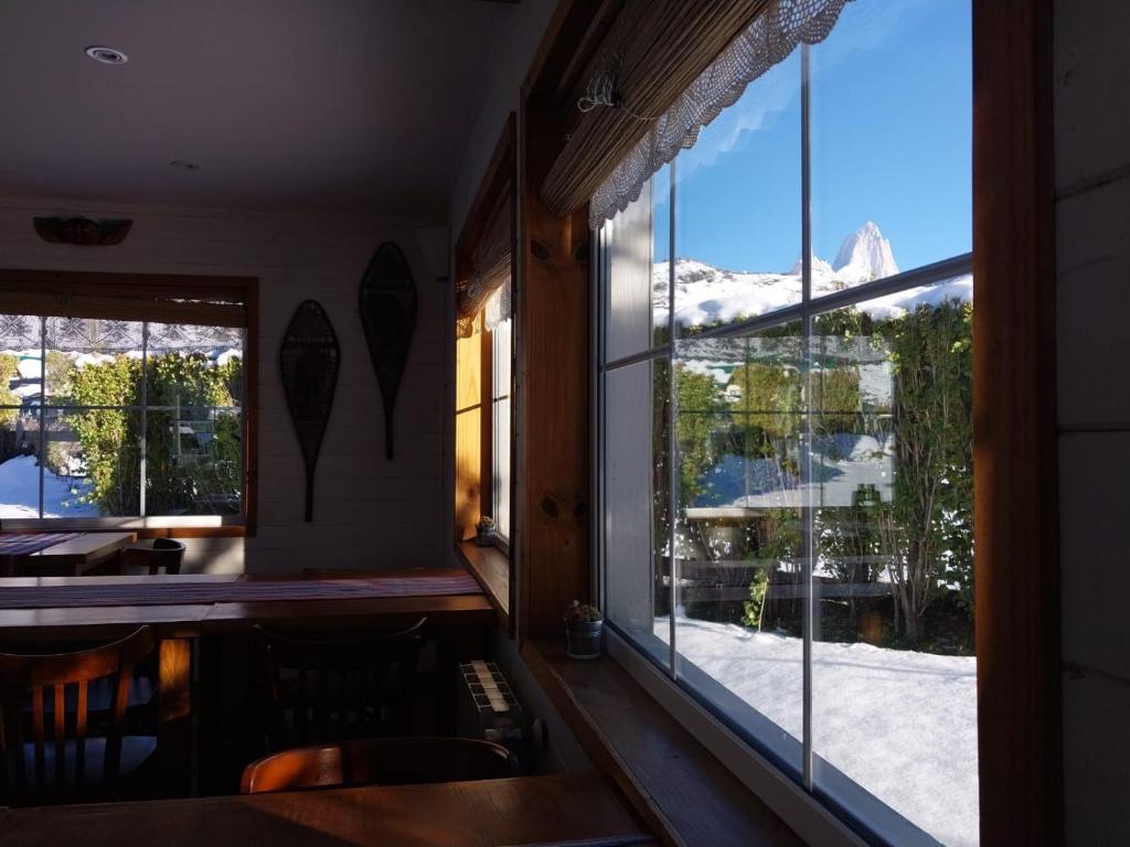 Una cocina con una ventana que da a una montaña cubierta de nieve. en Nothofagus Bed & Breakfast, en El Chaltén