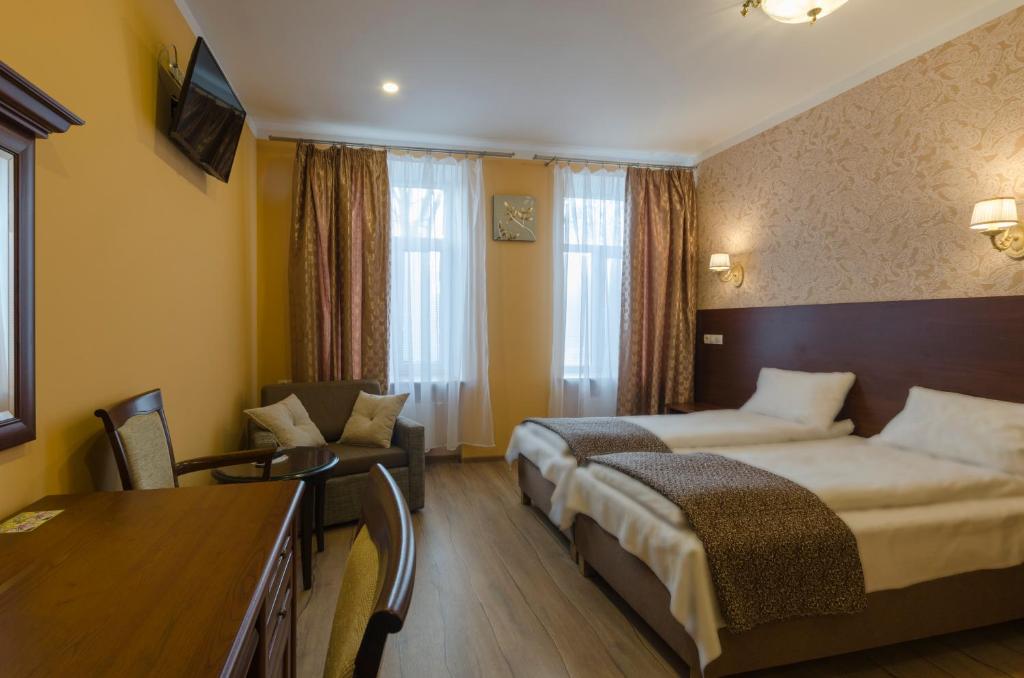 Postel nebo postele na pokoji v ubytování Gogol Park Rooms