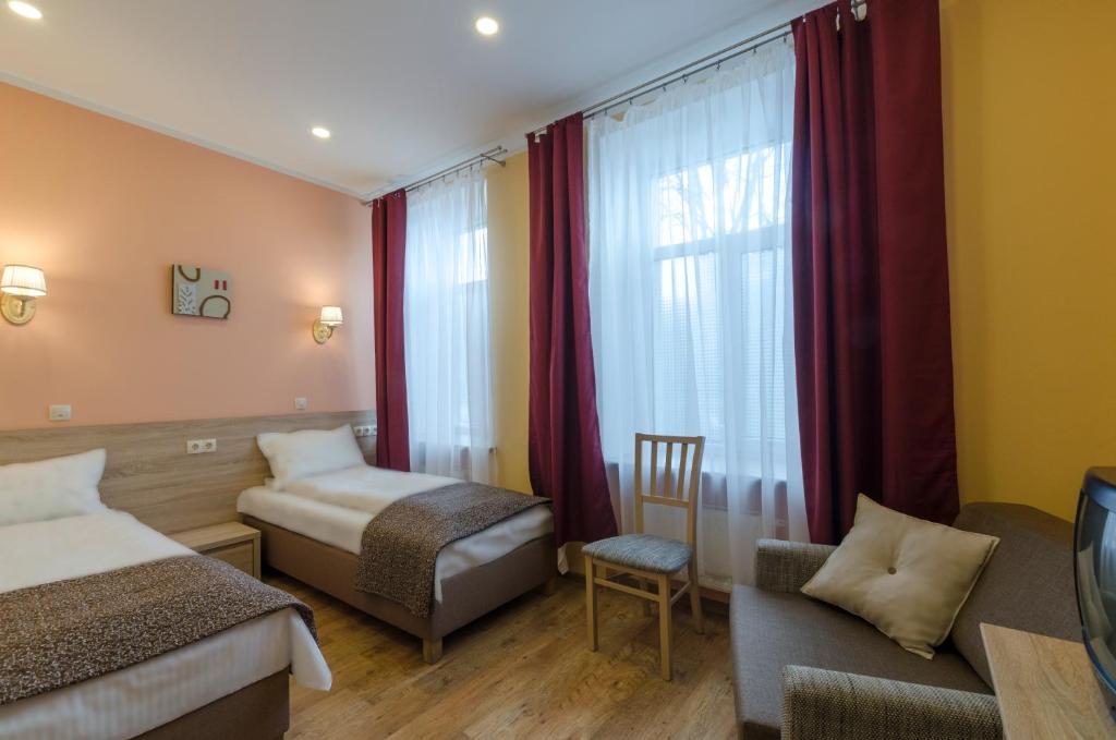 Postel nebo postele na pokoji v ubytování Gogol Park Rooms