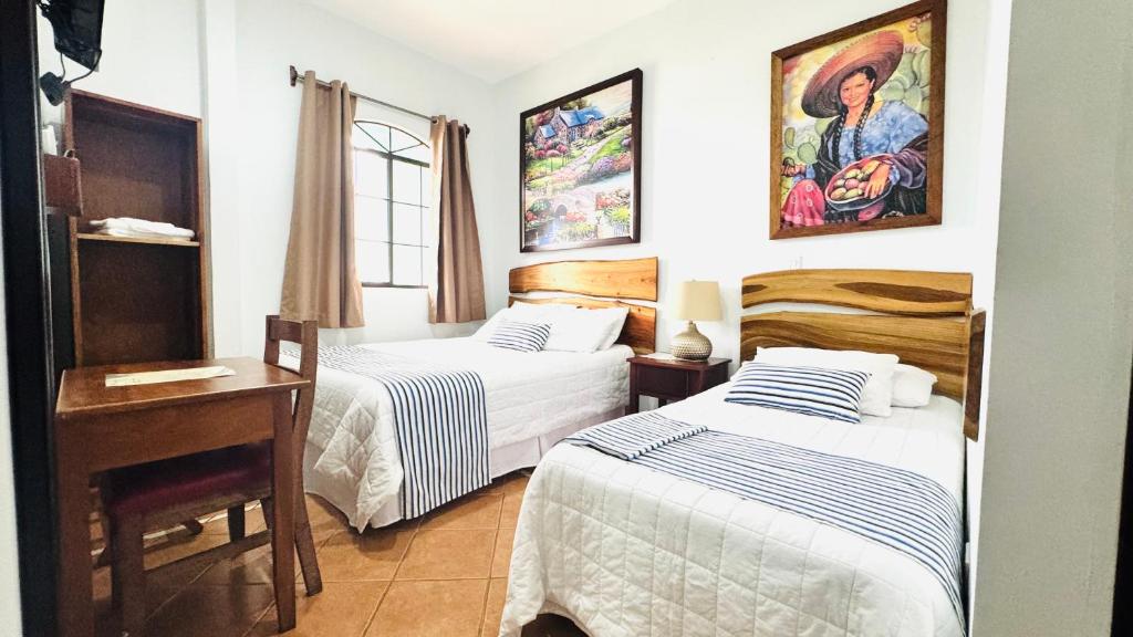 Ένα ή περισσότερα κρεβάτια σε δωμάτιο στο Hotel León Inn