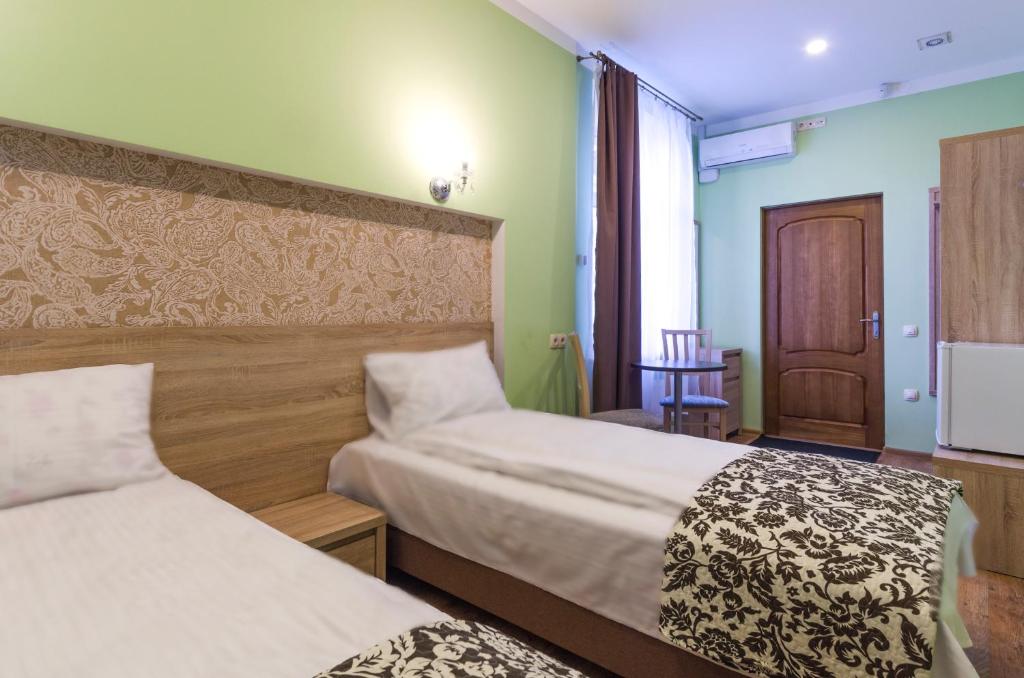 Postel nebo postele na pokoji v ubytování Gogol Park Rooms