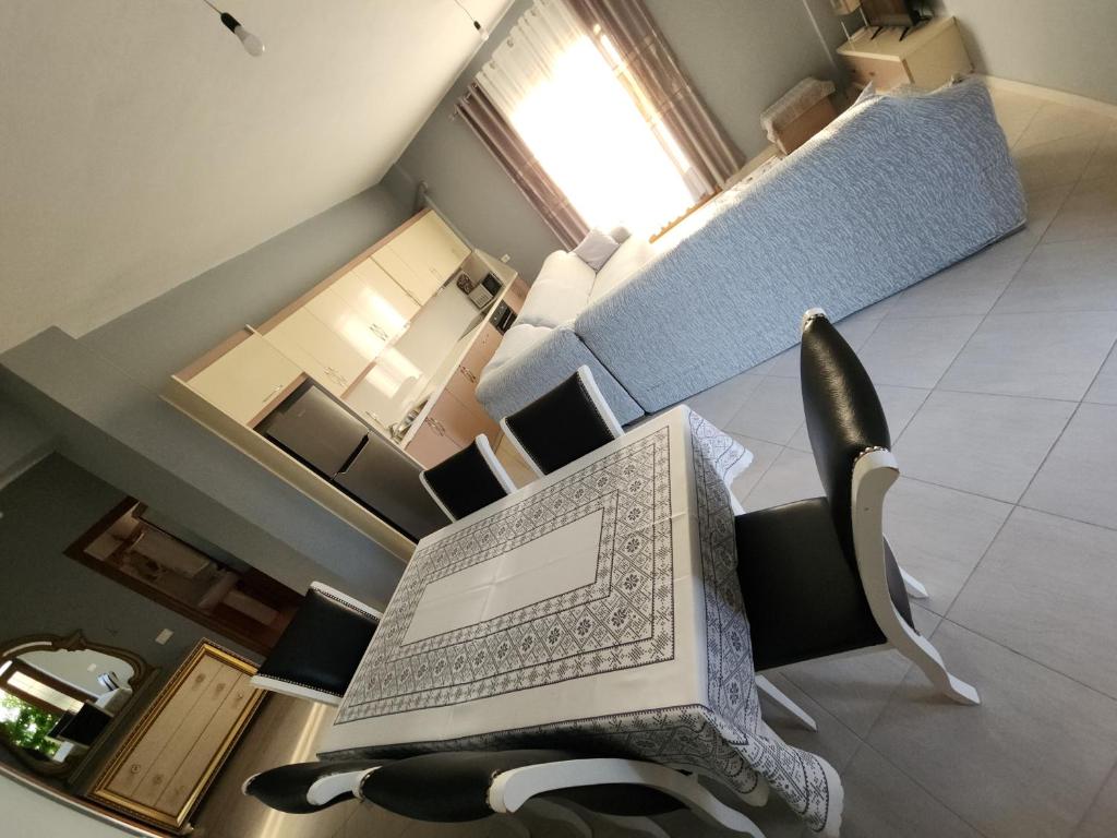 a room with a chair with a book on it at Villa Arilena in Sarandë