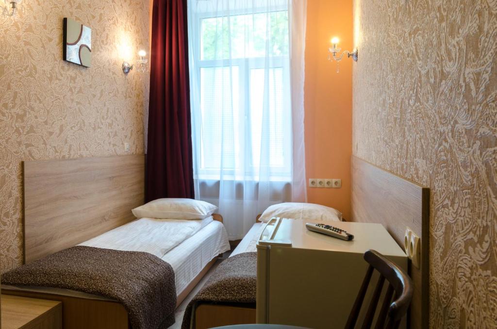 Postel nebo postele na pokoji v ubytování Gogol Park Rooms