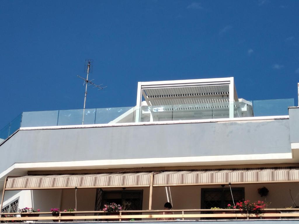 a white building with balconies on top of it at Attichetto monolocale vista mare terrazzatissimo Asterspace in Anzio