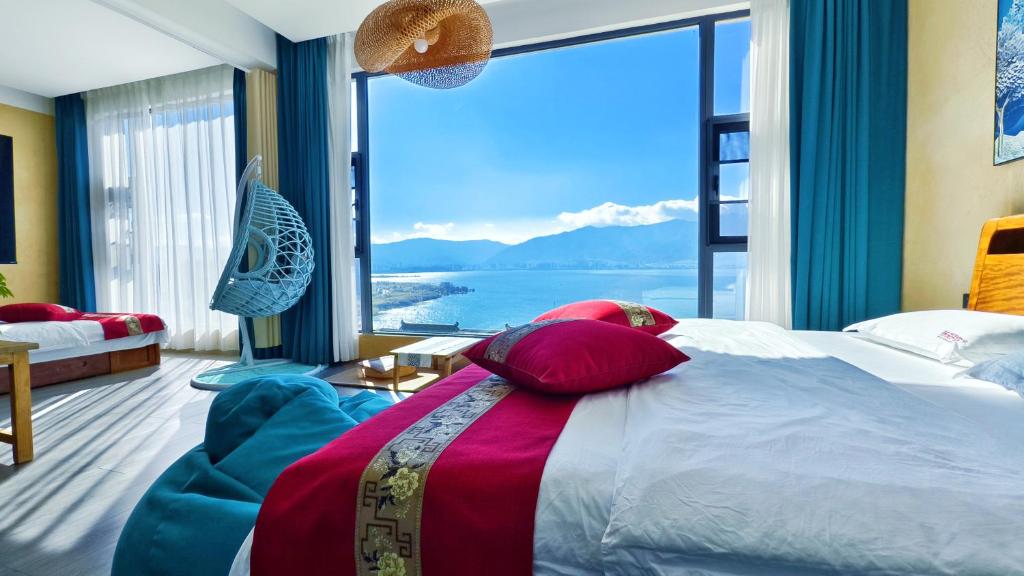 a bedroom with a large bed and a large window at Super Invincible All Seaview Villa in Dali