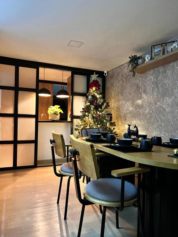 a dining room with a christmas tree and a table at Salento Boutique Mini House, Private, Complete in Salento