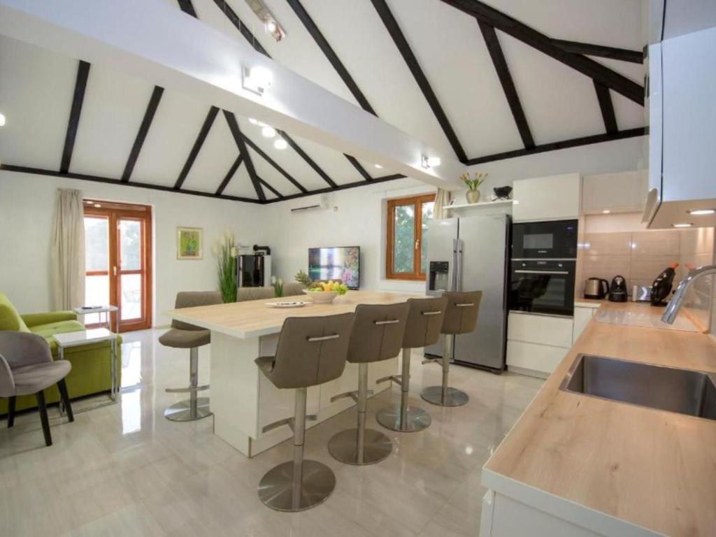 a kitchen with a kitchen island with bar stools at Villa Gabriel - Three Bedroom Villa with Outdoor Pool in Drniš