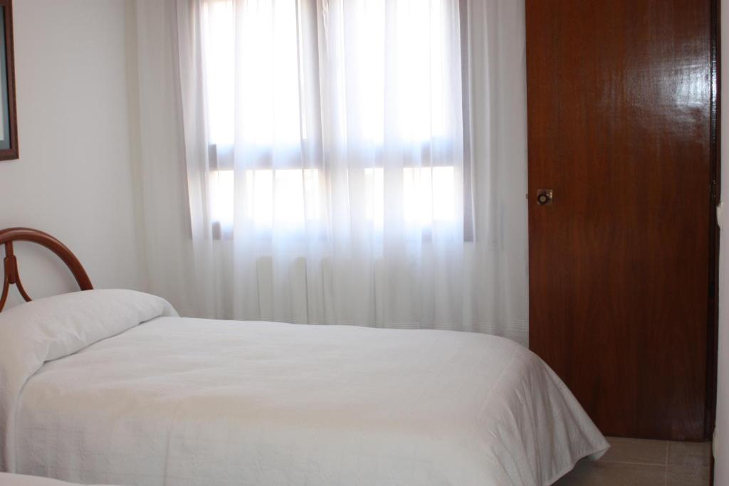 Postel nebo postele na pokoji v ubytování Apartamento Avenida