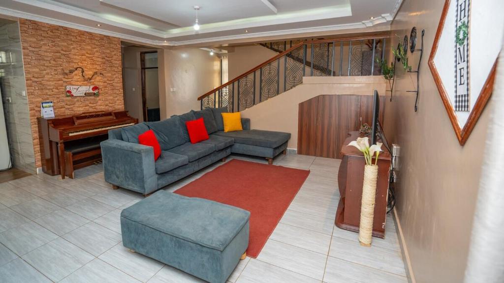 a living room with a couch and a piano at Syokiton Private Home near JKIA Airport in Syokimau