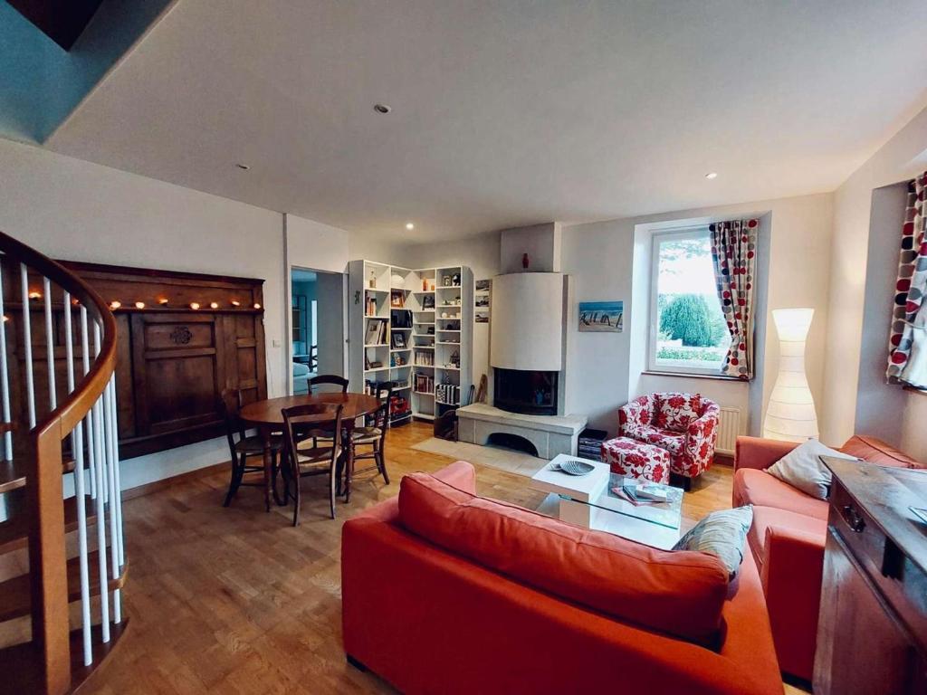 un salon avec un canapé rouge et une table dans l'établissement Maison confortable Côte de Granit Rose avec parking - FR-1-542-75, à Trégastel
