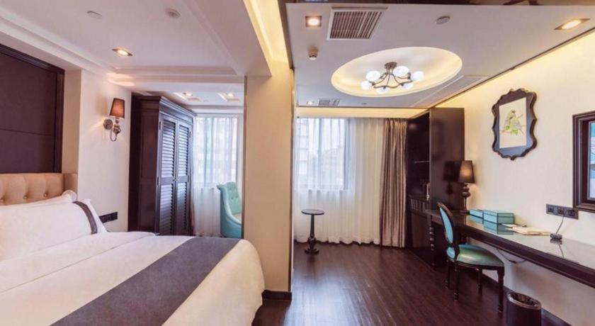 a hotel room with a bed and a desk in it at Xana Hotelle Xiamen Airport Zone Government in Xiamen