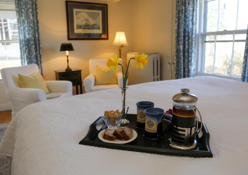 a tray of food and coffee on a bed at Marshall Slocum Inn in Newport