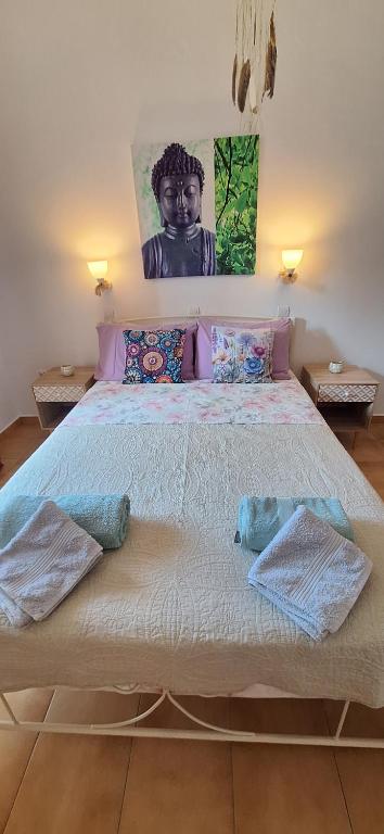 a bedroom with a large bed with two pillows at Sausan Hotel in Sidari