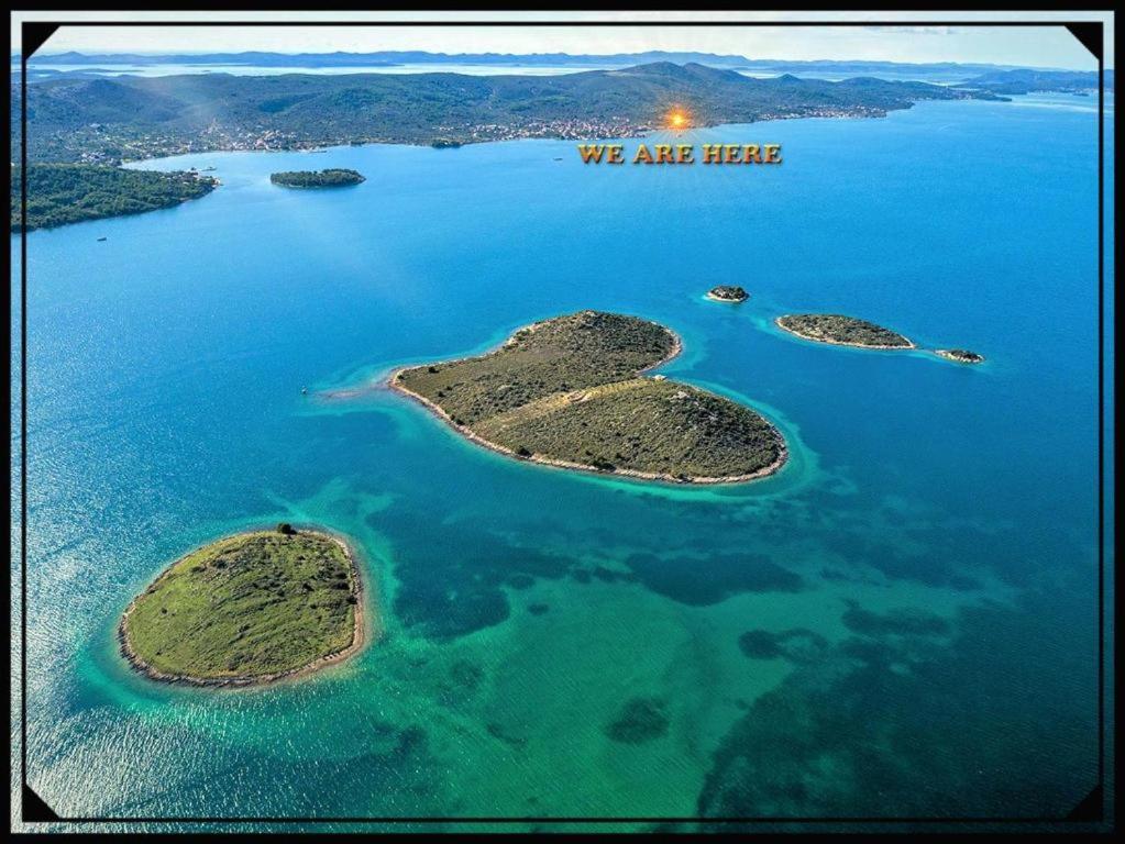 an aerial view of three islands in the water at Villa Olive Island in Neviđane