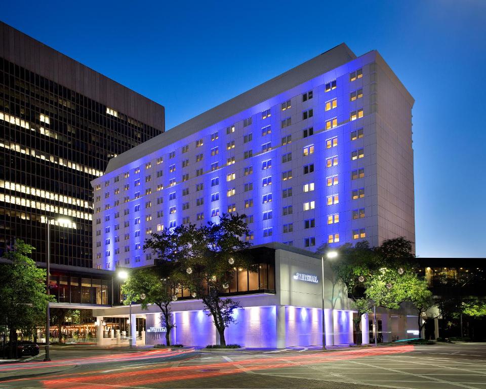 a large building with blue lights in front of it at The Whitehall Houston in Houston