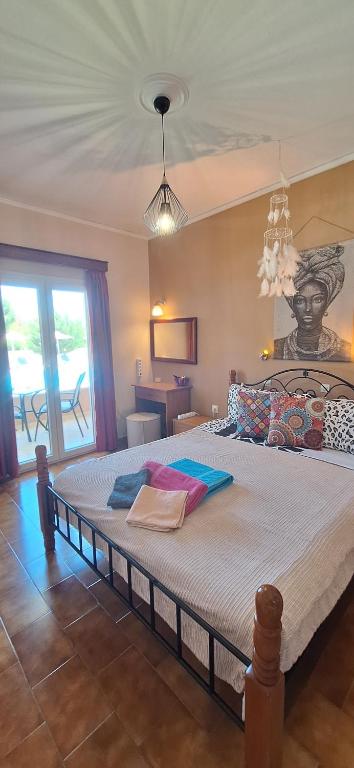 a bedroom with a large bed with a statue on the wall at Sausan Hotel in Sidari