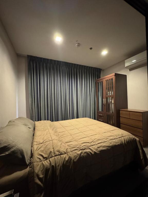 a bedroom with a large bed and a dresser at River Cando Perfect for relaxing in Ban Sai Ma