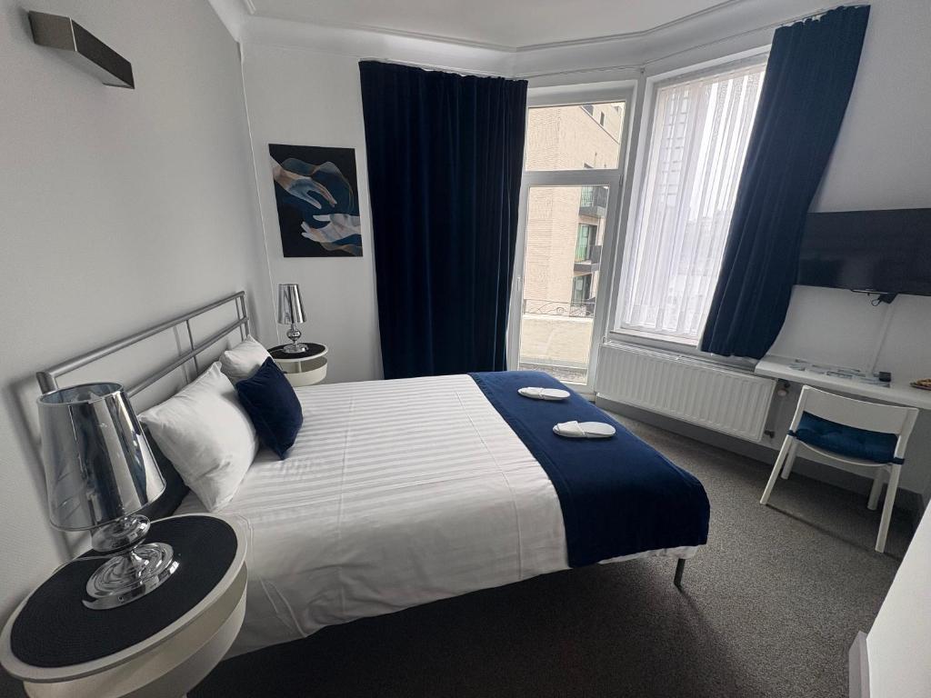 a hotel room with a bed and a window at Eurotel in Liège