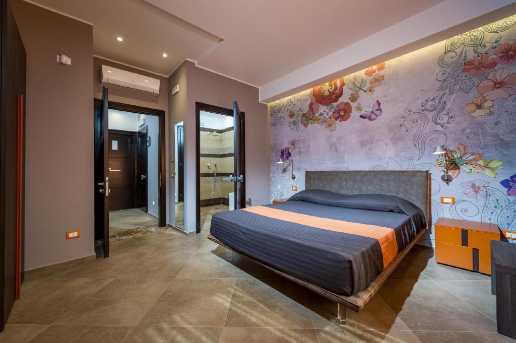 A bed or beds in a room at Hotel Vento del Sud