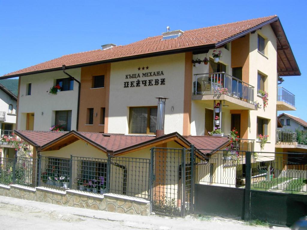 a building with a fence in front of it at Kashta Peychevi in Govedartsi