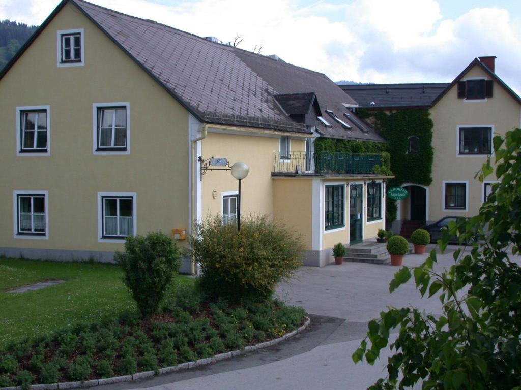 a large yellow house with a black roof at Landhaus Kügler-Eppich in Proleb