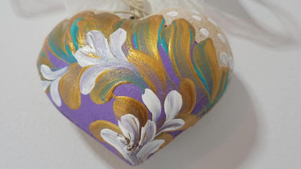 a heart shaped vase with a flower painted on it at Ioni Home in Tsagarada