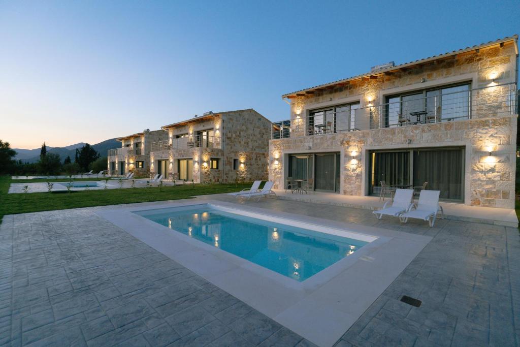 a house with a swimming pool in front of it at Onysis in Margarítion