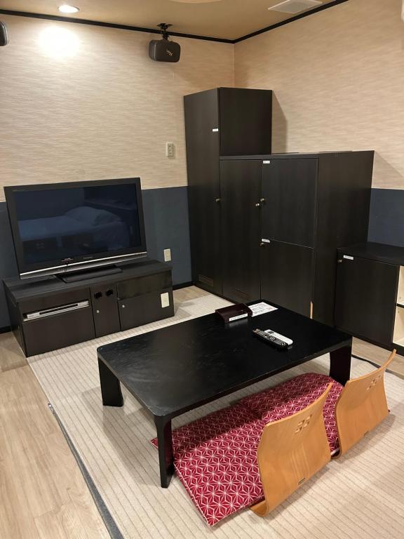 TV a/nebo společenská místnost v ubytování Hotel Takao Asile